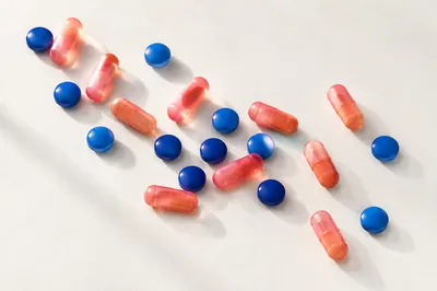 Assorted Capsules and Blue Tablets Flat Lay