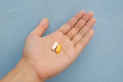 Medicine Capsules Resting in Open Palm
