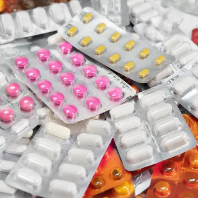 Assorted Medicine Blister Packs on Pharmacy Counter