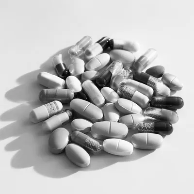 Monochrome Medicine Capsules on White Surface
