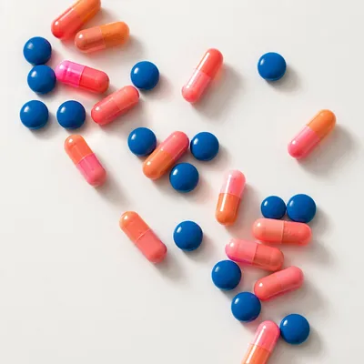 Assorted Capsules and Blue Tablets Flat Lay