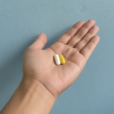 Medicine Capsules Resting on Open Palm