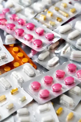 Assorted Medicine Blister Packs on Pharmacy Counter