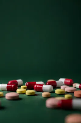 Medicine Capsules and Tablets on Green Surface