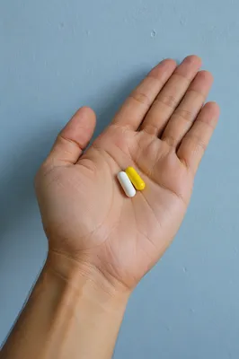 Medicine Capsules Resting in Open Palm