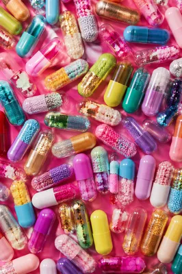 Colorful Capsules on Vivid Pink Surface