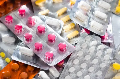 Assorted Medicine Blister Packs on Pharmacy Counter