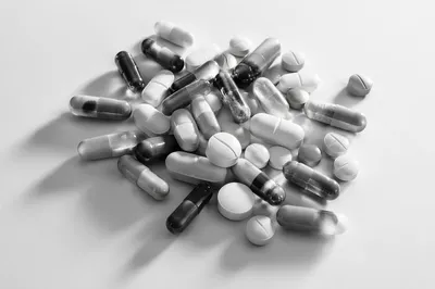Monochrome Medicine Capsules on White Surface