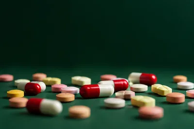 Medicine Capsules and Tablets on Green