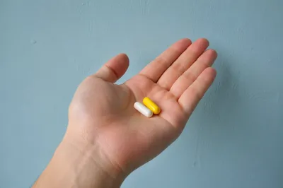 Medicine Capsules Resting in Open Palm