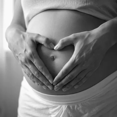 Protective Hands Around Pregnant Belly Portrait
