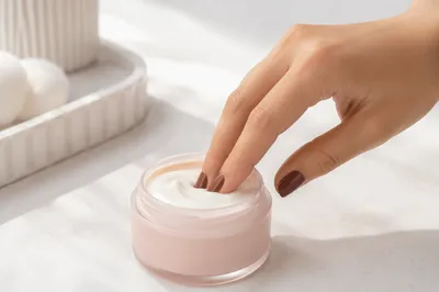 Close-Up Hand Dipping Face Cream