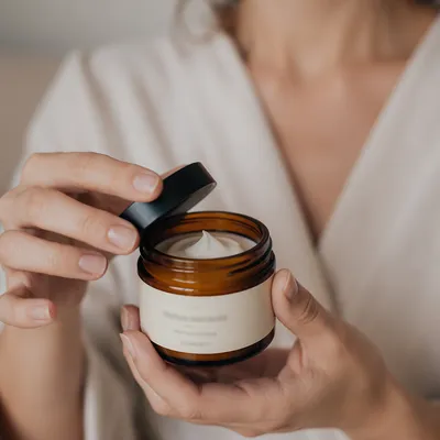 Close-Up Face Cream Jar in Hands
