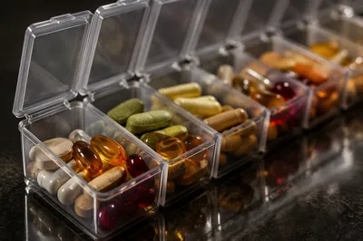 Weekly Vitamin Organizer on Reflective Table