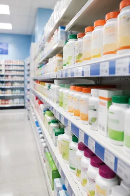 Pharmacy Supplement Aisle With Vitamin Bottles