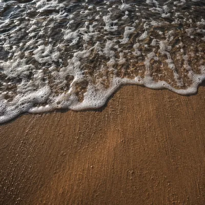 Tropical Wave Foam Over Golden Sand