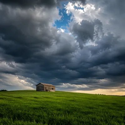 Green Countryside Hill Under Storm Clouds