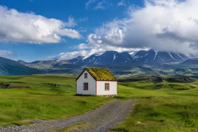 White Cottage in Expansive Green Meadow