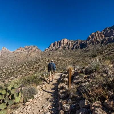 Lone Hiker on Desert Mountain Trail