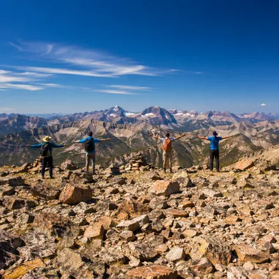 Joyful Hikers on Alpine Mountain Ridge