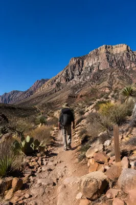Desert Hiker Trail Toward Rugged Mountains