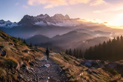 Dawn Hiker Beneath Misty Alpine Peaks