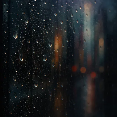 Rain Droplets on Blurred Window at Dusk
