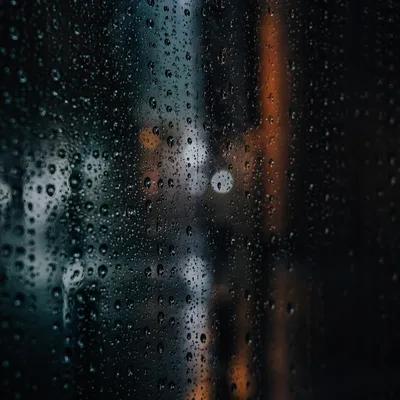Rain Droplets on Window at Dusk