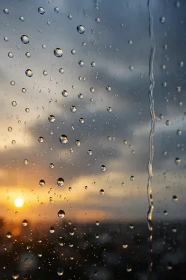 Rain Droplets on Window at Golden Hour