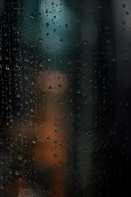 Rain Droplets on Blurred Window at Dusk