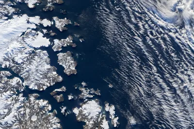 Dramatic Arctic Coastline Under Sweeping Clouds