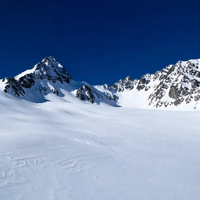 Silent Snowy Alpine Peaks Under Cobalt Sky