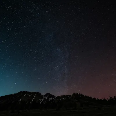Dark Starry Sky Over Mountain Silhouette