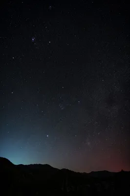 Serene Starry Night Over Mountain Silhouette