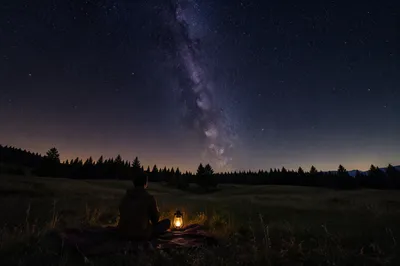 Contemplative Figure Beneath Starry Night Sky