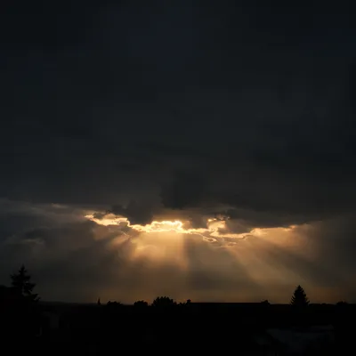Golden Sun Rays Breaking Storm Clouds