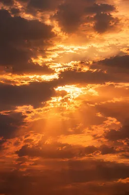 Golden Sun Rays Through Dramatic Clouds