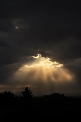 Golden Sun Rays Breaking Through Storm Clouds