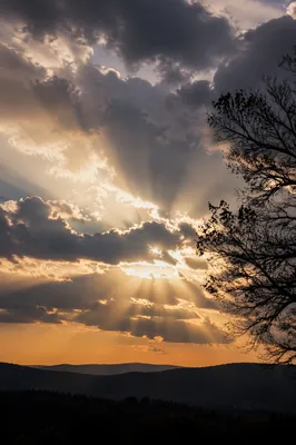 Golden Sun Rays Through Storm Clouds