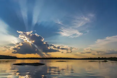 Sun Rays Breaking Through Lakeside Clouds
