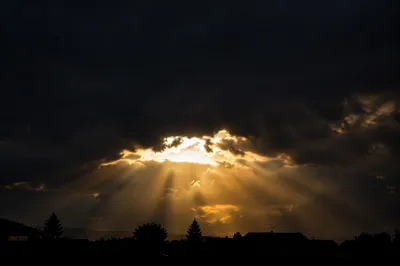 Golden Sun Rays Breaking Storm Clouds