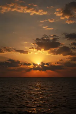 Golden Sunset Ocean Horizon with Reverent Clouds