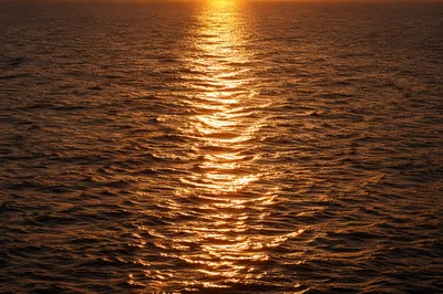 Golden Sunset Reflections Over Calm Ocean