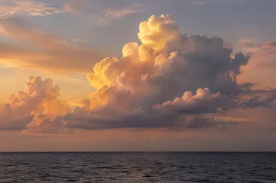 Golden Sunset Clouds Over Calm Ocean
