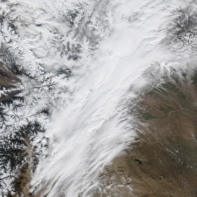 Aerial Blizzard Over Winter Mountain Plains