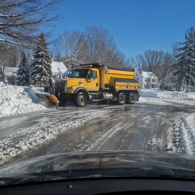 Snowplow Crossing Blizzard-Covered Winter Road