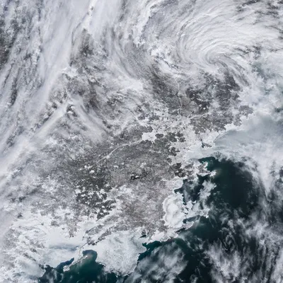 Blizzard Over Frozen Coastal Winter Roads