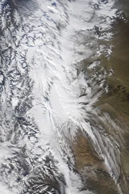 Aerial Blizzard Over Mountains and Plains