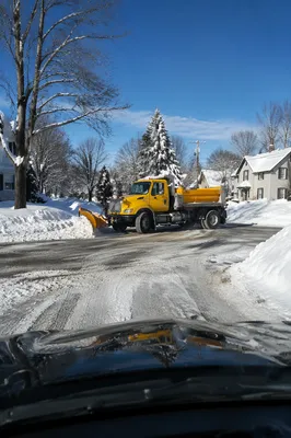 Snowplow Crossing Blizzard Covered Suburban Road