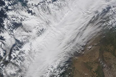 Aerial Blizzard Over Winter Mountain Plains
